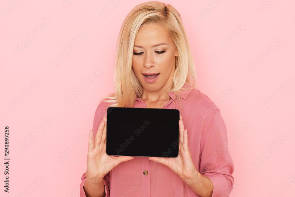Horizontal picture of enthusiastic model with a new tablet. Horizontal picture of enthusiastic model with a new tablet.