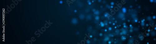 Computer generated plenty of blue spots big and small with bokeh on a black background. Widescreen 3d rendering