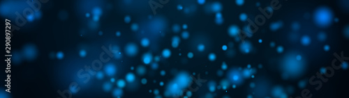 Computer generated plenty of blue spots big and small with bokeh on a black background. Widescreen 3d rendering