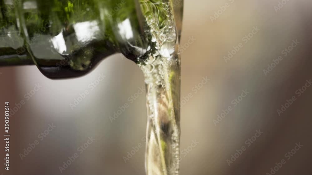 Pouring champagne through the spoon. Macro. Slow motion. Pouring champagne through the spoon. Macro. Slow motion.