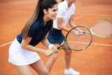 Happy fit people playing tennis together. Sport concept