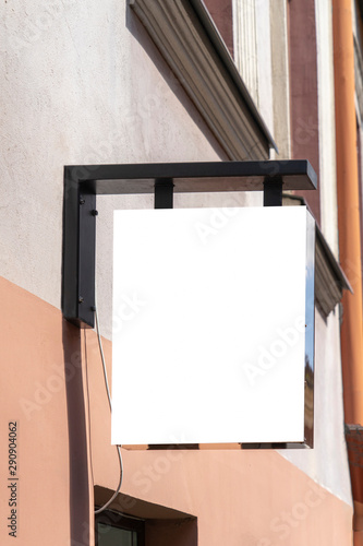 Blank white mock up of street signboard in european old town