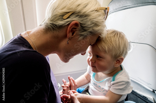Mom spending time with her one year old baby boy during flight