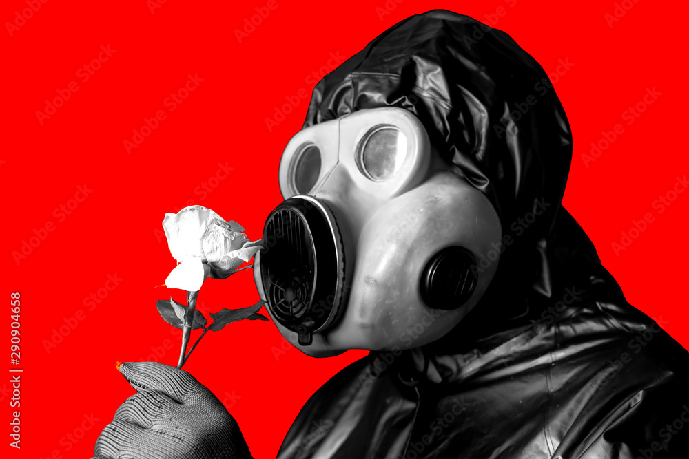 Man in the gas mask holding flower isolated on background. Radiation influence. Environmental pollution. Chernobyl concept. Dangerous nuclear power. Stock Photo | Adobe Stock