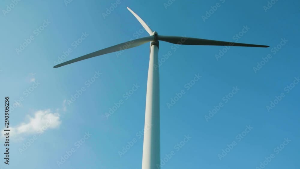Low angle shot of a windmill against the clear blue sky. Green Energy Low angle shot of a windmill against the clear blue sky. Green Energy