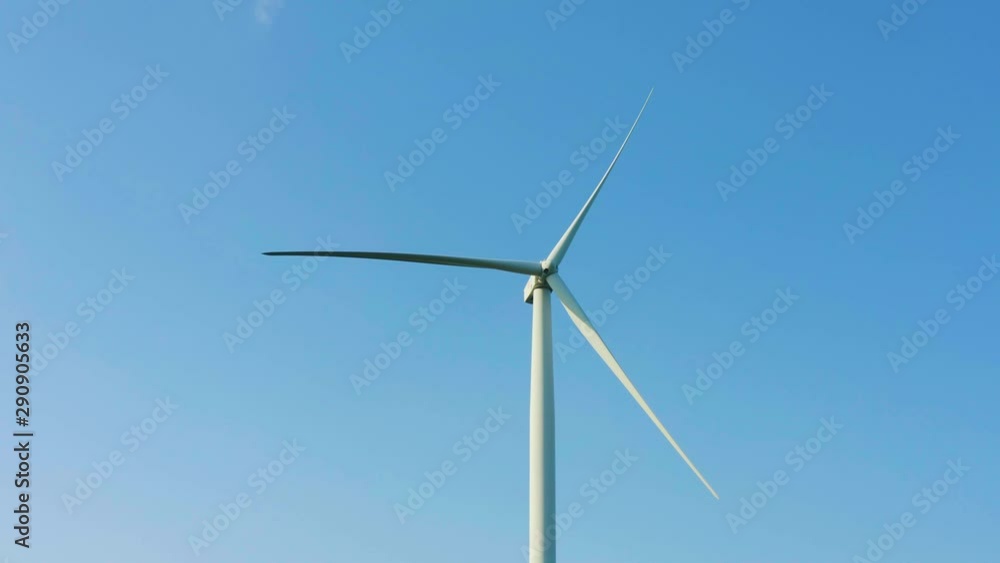 Low angle shot of a windmill against the clear blue sky. Green Energy Low angle shot of a windmill against the clear blue sky. Green Energy