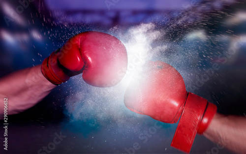 boxing gloves punch boxer fight on black background © artefacti