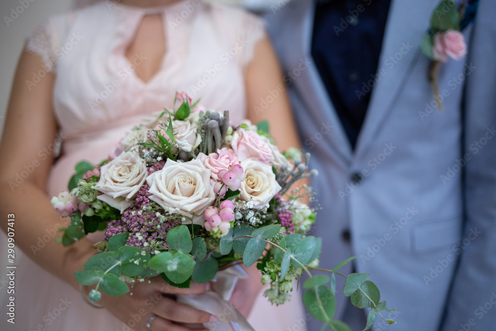 wedding bouquet in hands of bride and groom wedding bouquet in hands of bride and groom