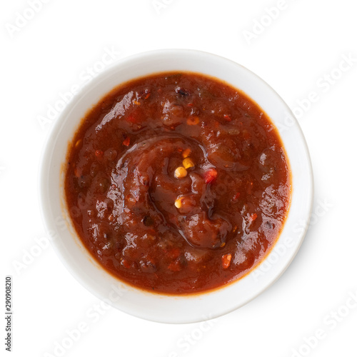 Salsa sauce in a white bowl, isolated on white background. Top view