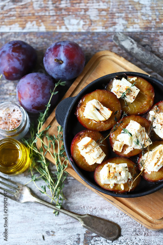 Keto snack. Baked plums with feta cheese and thyme. Keto friendly. Selective focus. Macro.