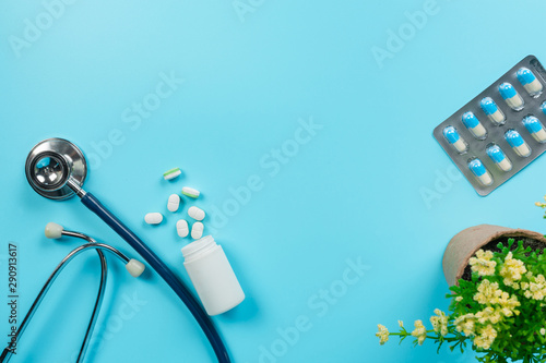 Concept of medicine, medical supplies placed with doctor tools on a blue background.