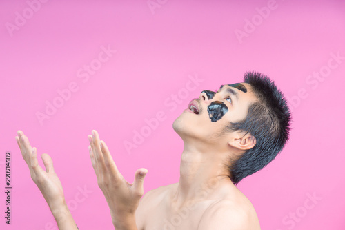 Handsome men who apply black cosmetics on their faces, showing various postures with a pink background.