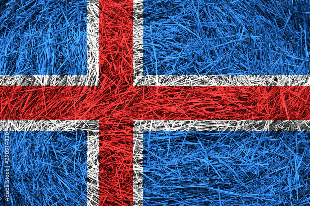 Iceland flag on hay roll surface.