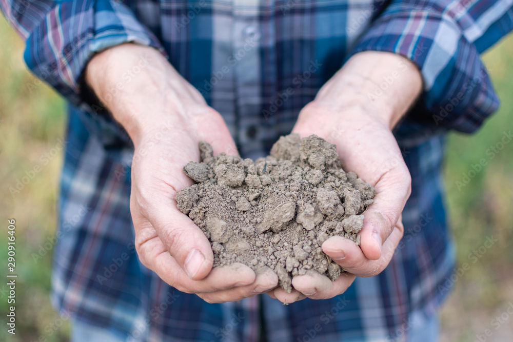 Farmer hands with soil in the palms close-up , man hands with fertile soil Farmer hands with soil in the palms close-up , man hands with fertile soil