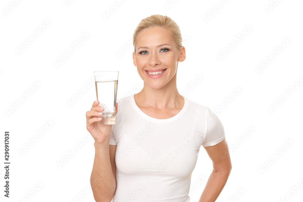 Beautiful smiling model is holding a glass of water. Beautiful smiling model is holding a glass of water.