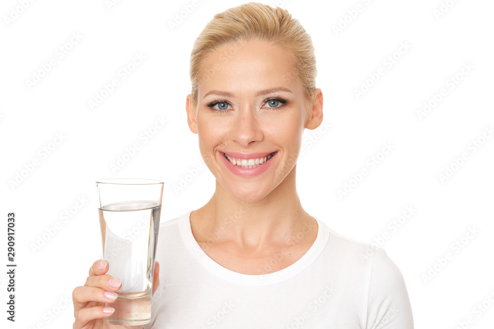 Beautiful smiling model is holding a glass of water. Beautiful smiling model is holding a glass of water.