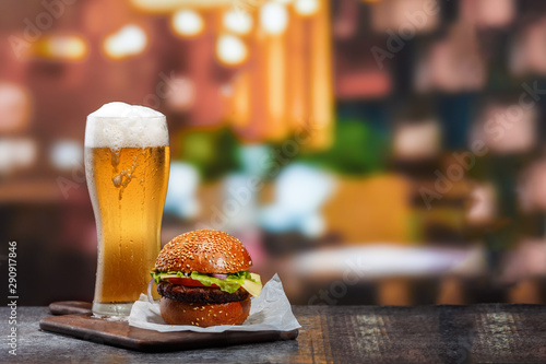 Photos Frosty glass of light beer with hamburger