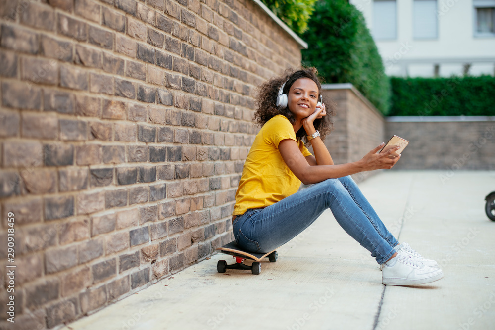 African skater girl using phone