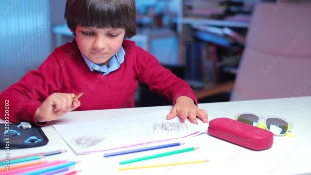 the boy finishes drawing a drawing and rejoices raising his hands the boy finishes drawing a drawing and rejoices raising his hands