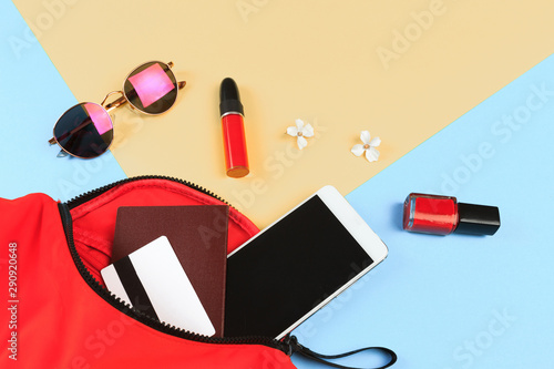 Top view of Women bag and lady stuff with copyspace on colour background- Image