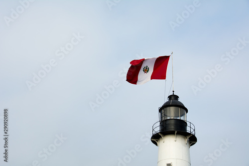 Obraz na plátně peruvian flag flying from lighthouse