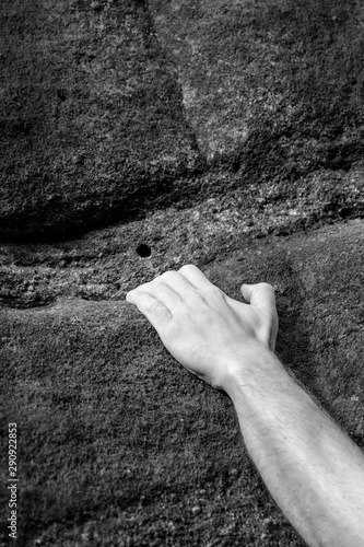 hand climbing the wall