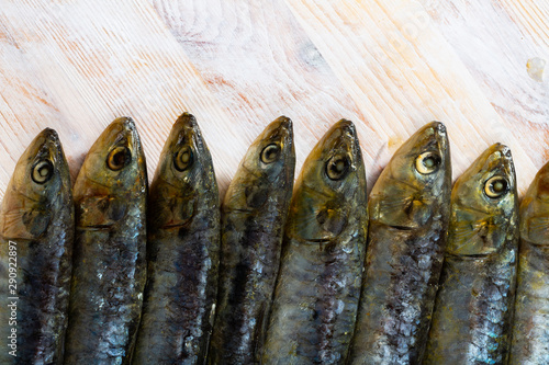 Marinated sardines on wooden table photo