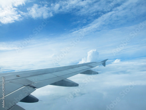 Airplane wing with sky Clouds in the background