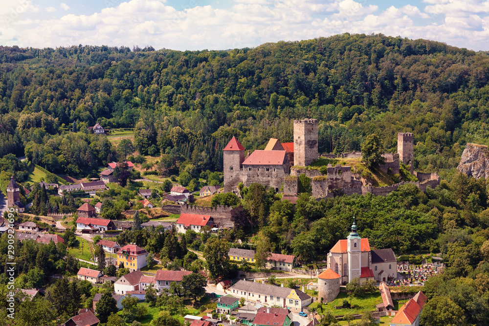 Burg Hardegg - a castle in Lower Austria, Austria. Woodland around, summer day with blue sky with white clouds.