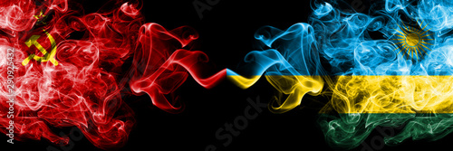 Communist vs Rwanda, Rwandan abstract smoky mystic flags placed side by side. Thick colored silky smoke flags of Communism and Rwanda, Rwandan photo