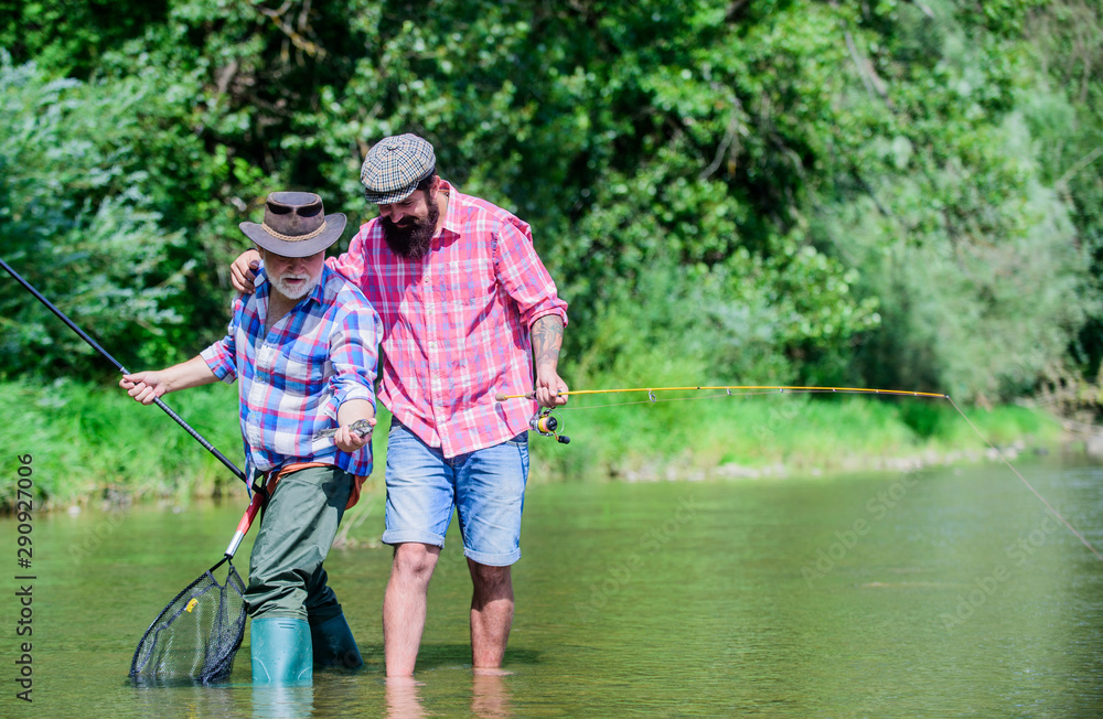 Father and son fishing. Nice catch. Rod and tackle. Fisherman fishing equipment. Fisherman grandpa and mature man friends. Fisherman family. Hobby sport activity. Summer weekend. Peaceful activity