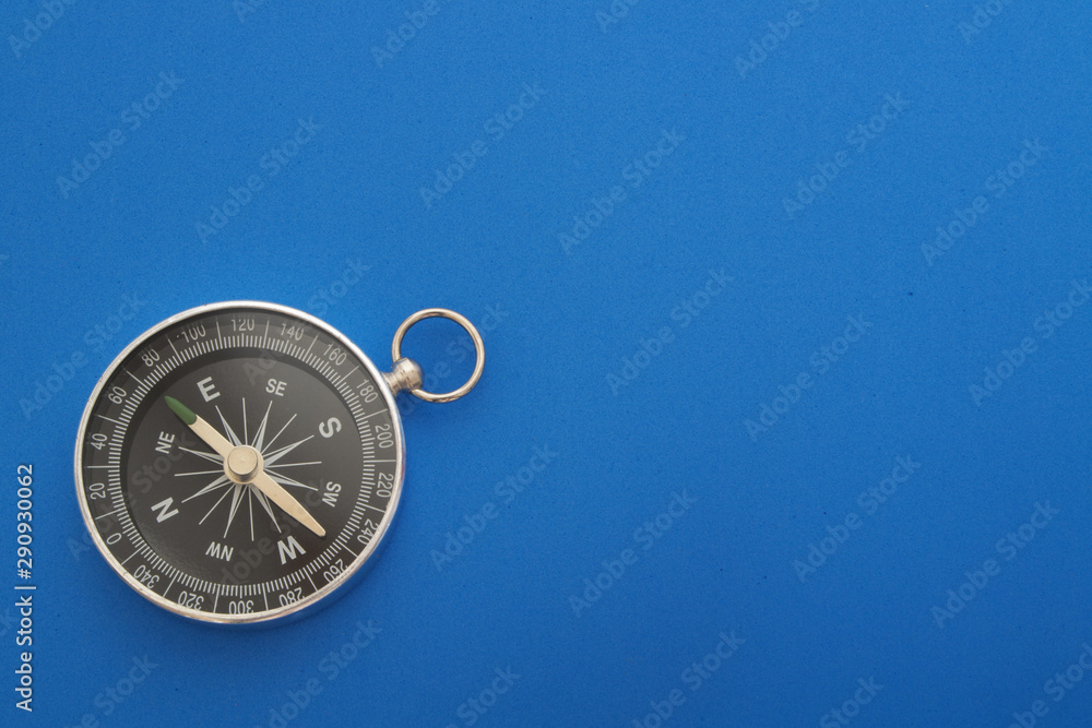 Compass on blue background with sp[ace for text