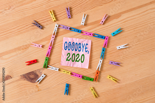 Text sign showing Goodbye 2020. Business photo showcasing New Year Eve Milestone Last Month Celebration Transition Colored clothespin papers empty reminder wooden floor background office photo