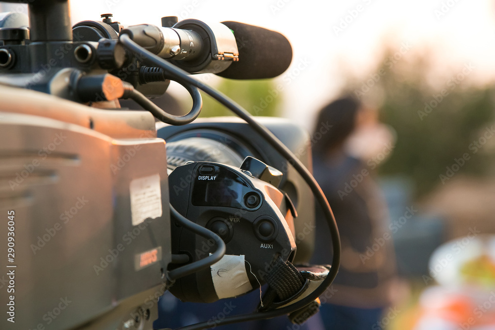 Obraz premium TV Camera and presenter host on a live news broadcast on location