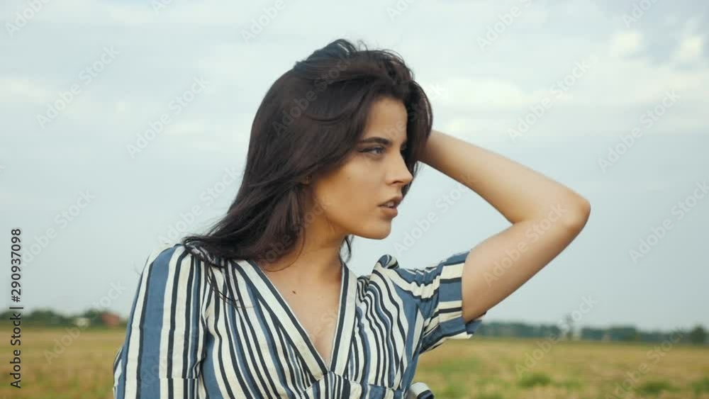 Beautiful girl enjoys nature in the field and rests emotionally in harmony with nature. Slow motion. Beautiful girl enjoys nature in the field and rests emotionally in harmony with nature. Slow motion.