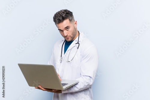 Caucasian doctor man with a laptop