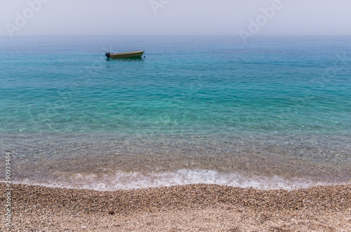 Small boat on the turqoise sea
