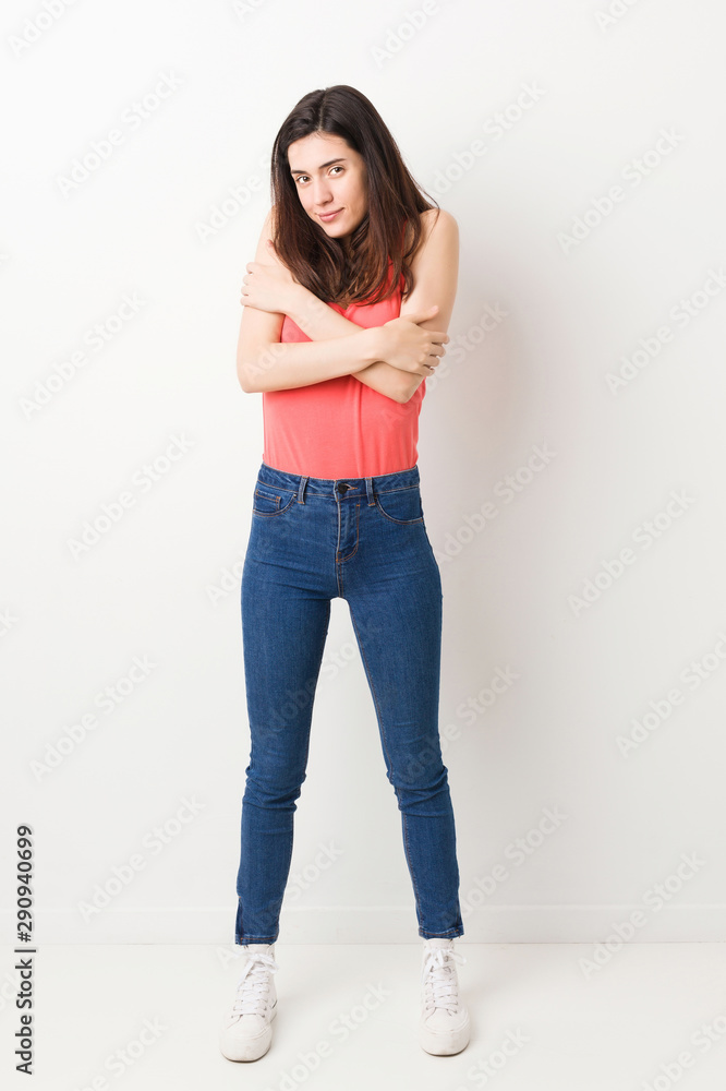 Full body young woman on white background going cold due to low temperature or a sickness. Full body young woman on white background going cold due to low temperature or a sickness.