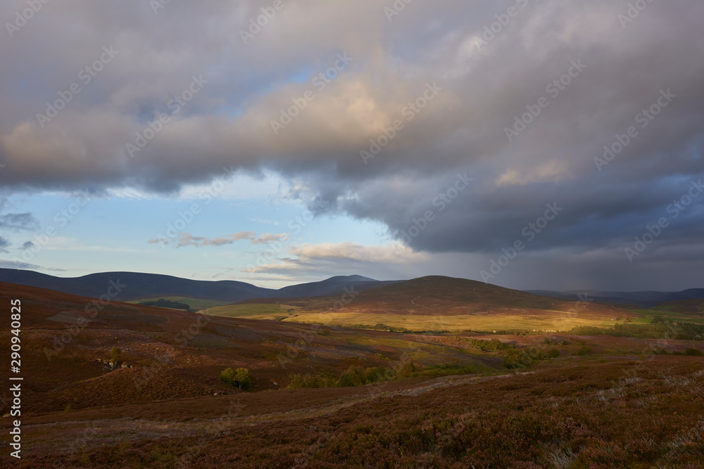Golden sunlight lighting up the slopes of the hills in the Angus Glens of Scotland on a Septembers evening, as seen from the Hill of Rowan. Golden sunlight lighting up the slopes of the hills in the Angus Glens of Scotland on a Septembers evening, as seen from the Hill of Rowan.