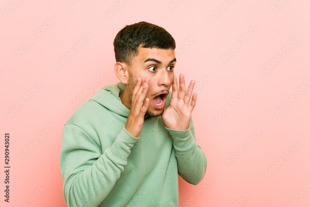 Young hispanic sport man shouts loud, keeps eyes opened and hands tense. Young hispanic sport man shouts loud, keeps eyes opened and hands tense.