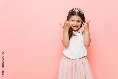 Little girl wearing a princess look upset screaming with tense hands.