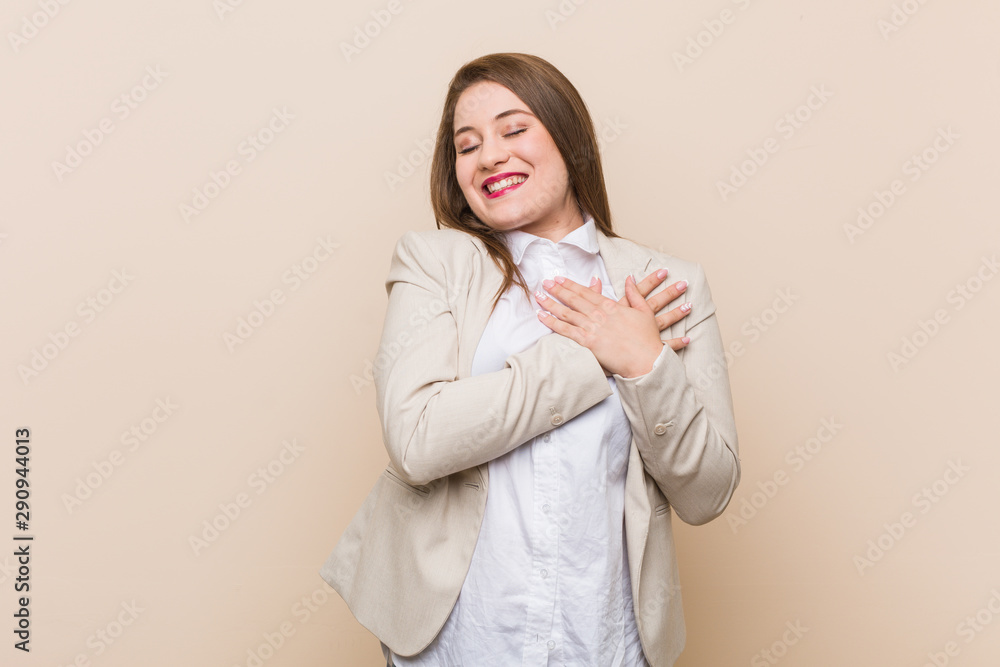 Young business woman laughing keeping hands on heart, concept of happiness. Young business woman laughing keeping hands on heart, concept of happiness.