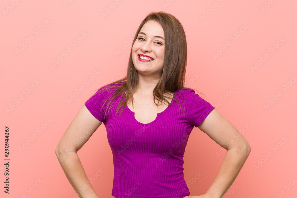 Young hispanic woman against a pink wall confident keeping hands on hips. Young hispanic woman against a pink wall confident keeping hands on hips.