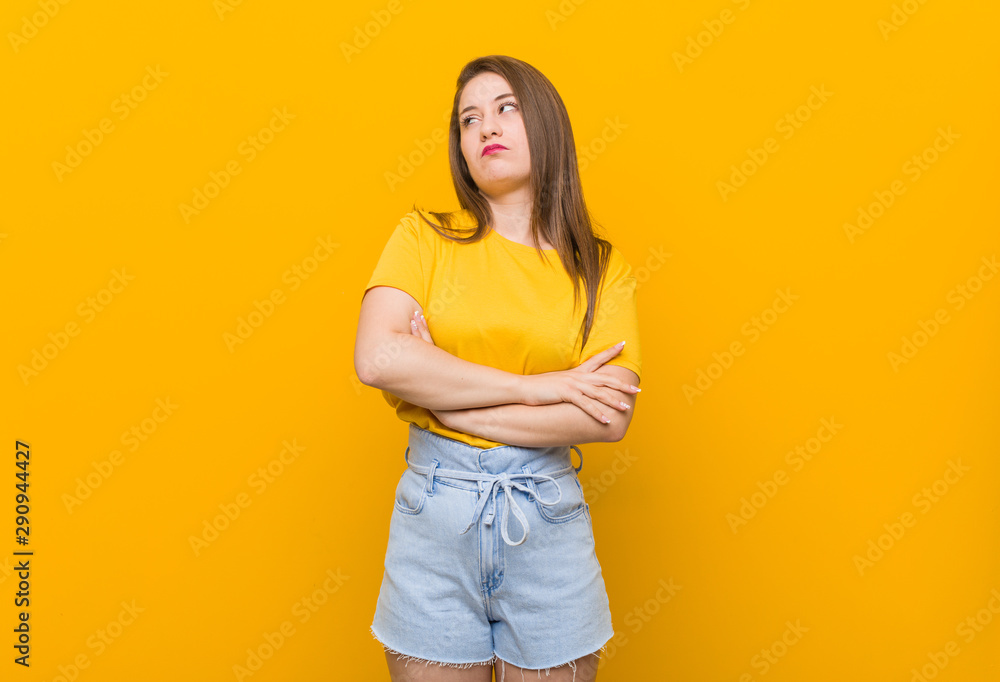 Young woman teenager wearing a yellow shirt tired of a repetitive task. Young woman teenager wearing a yellow shirt tired of a repetitive task.