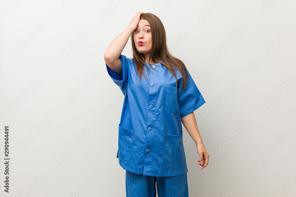 Young nurse woman against a white wall tired and very sleepy keeping hand on head. Young nurse woman against a white wall tired and very sleepy keeping hand on head.