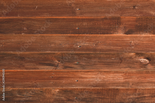 Texture of wooden boards of red tree. Vintage wooden fence, desk surface. Natural color. Weathered timber, background. Old wood planks. Pattern of redwood. Rustic table of alder. 