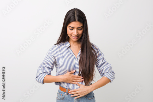 Obraz na płótnie Young pretty arab woman sick, suffering from stomachache, painful disease concept