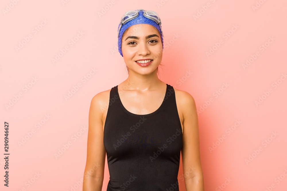 Young arab swimmer woman isolated happy, smiling and cheerful. Young arab swimmer woman isolated happy, smiling and cheerful.
