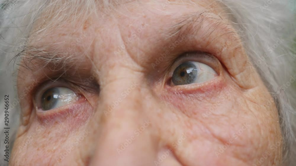 Eyes of old woman moving from side to side and then looking into camera. Eyes of an elderly lady with wrinkles around them. Close up Slow motion Eyes of old woman moving from side to side and then looking into camera. Eyes of an elderly lady with wrinkles around them. Close up Slow motion