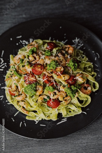 pasta tagliatelle with pesto, garlic shrimps and cherry